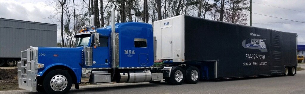 Double drop curtainside trailer and tractor heading to a customer's site
